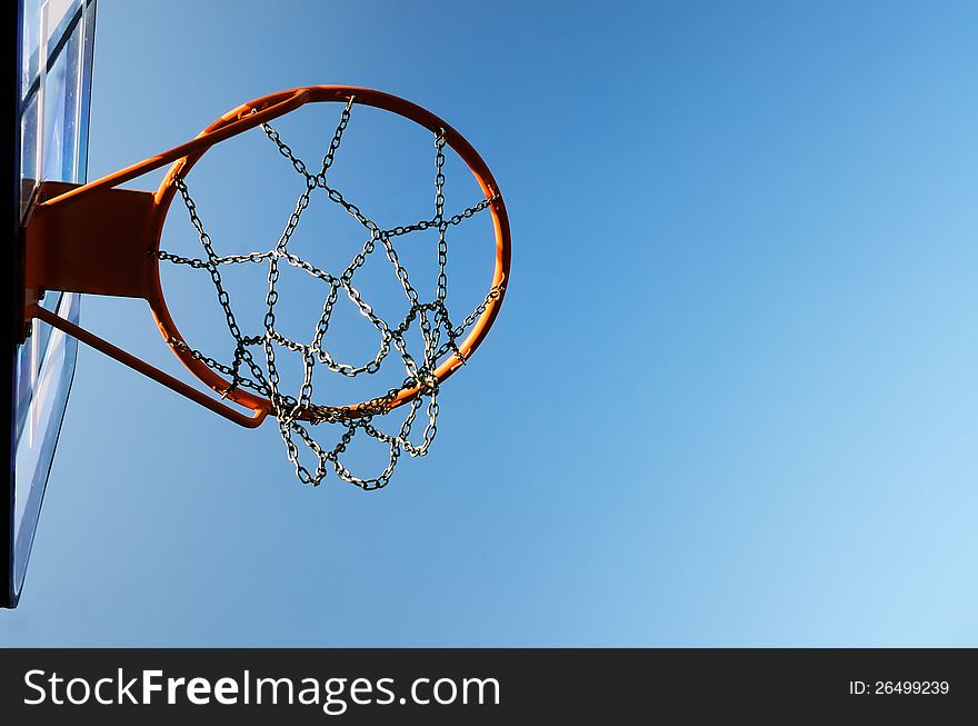 Basketball hoop against a blue sky