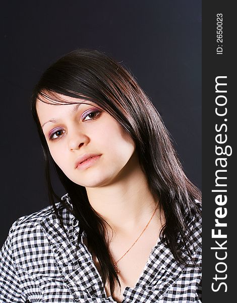 Portrait of the young charming woman on a black background. Portrait of the young charming woman on a black background