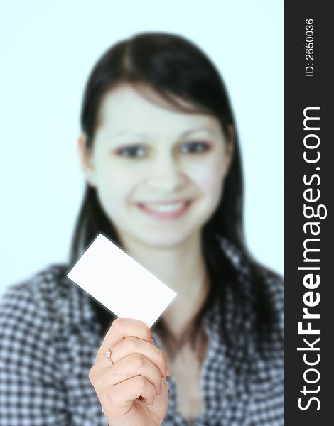 The young business woman holds a card. The young business woman holds a card