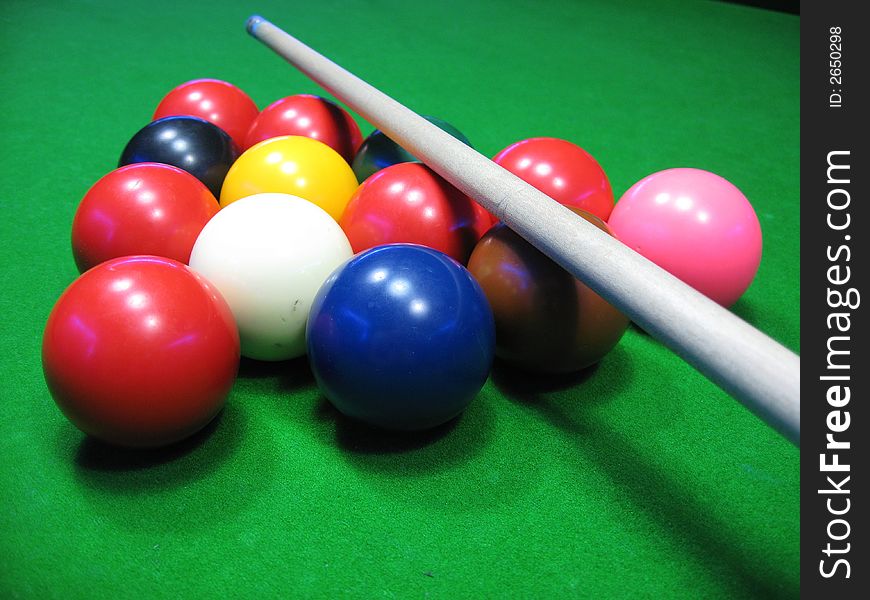 Billiards balls on a green table,billiard table and balls and cue