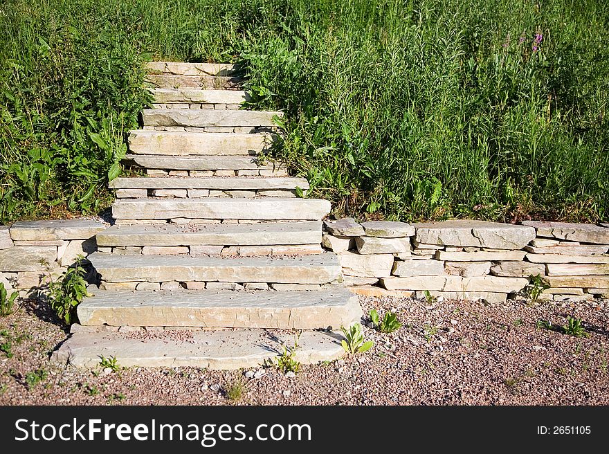 Stairs ending in to middle of grass field