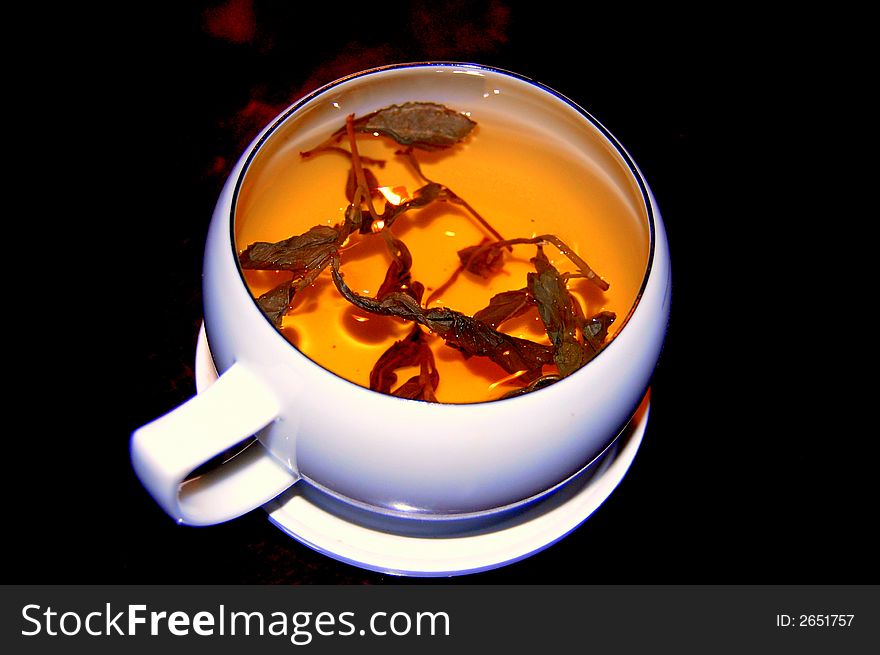 A cup of chinese tea on a red wood table