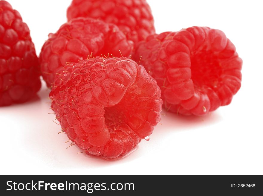 Ripe red raspberries isolated on a white background.