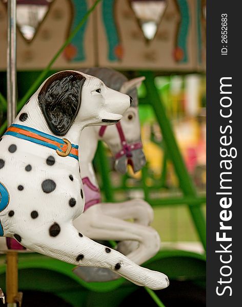 A dog on a carnival carousel is ready for the next rider. A dog on a carnival carousel is ready for the next rider.