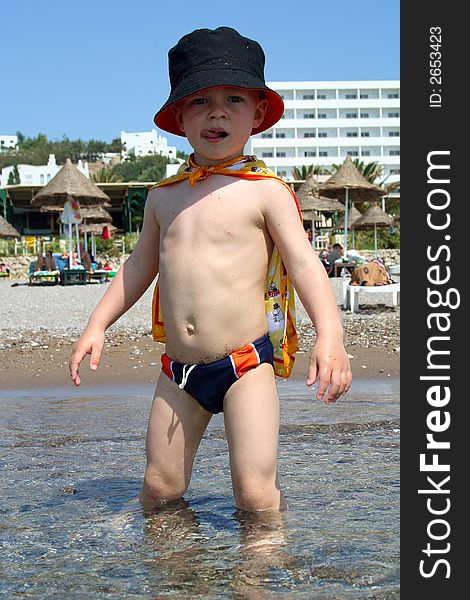 Small boy knee-deep in the sea, Rhodes, Greece. Small boy knee-deep in the sea, Rhodes, Greece