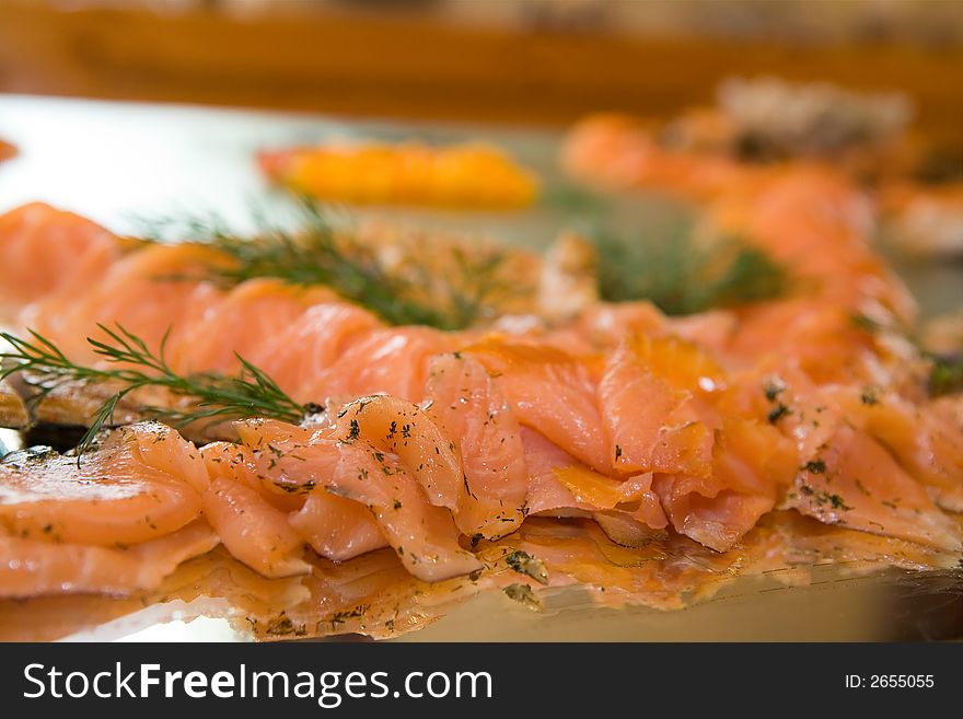 Close-up party platter full of sliced salmon. Focus on front salmon. Close-up party platter full of sliced salmon. Focus on front salmon.