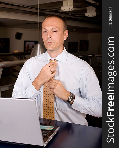 Business fixing his tie after hard work. Business fixing his tie after hard work