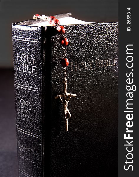 Red rosary and holy bible