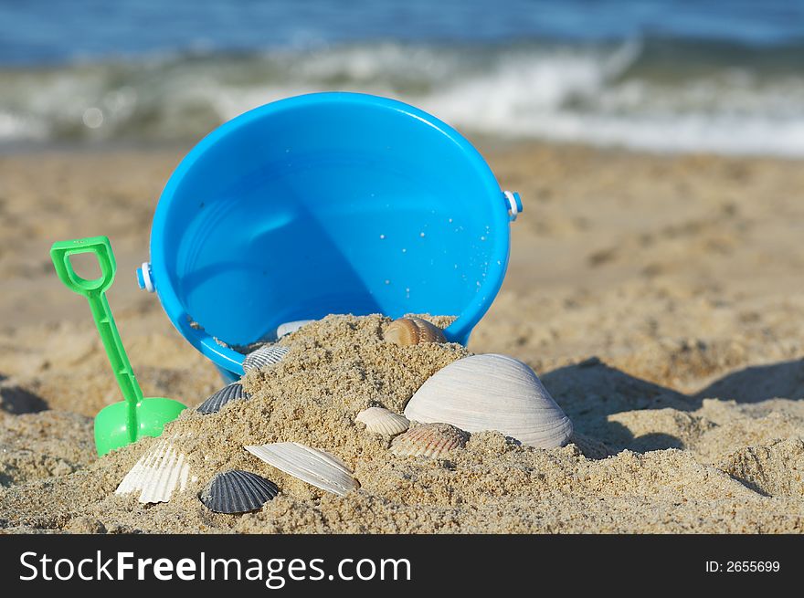Sand bucket on sand at the beach. Sand bucket on sand at the beach