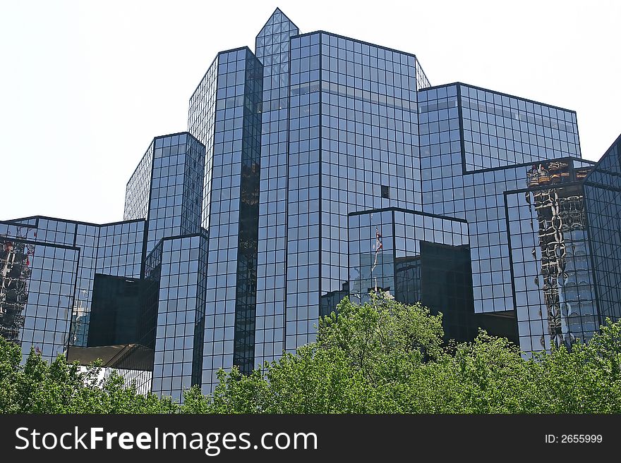 A massive blue glass financial center against the sky