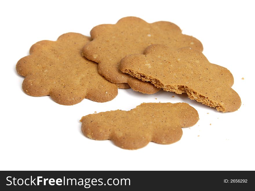 Three cookies and one broken cookie over white