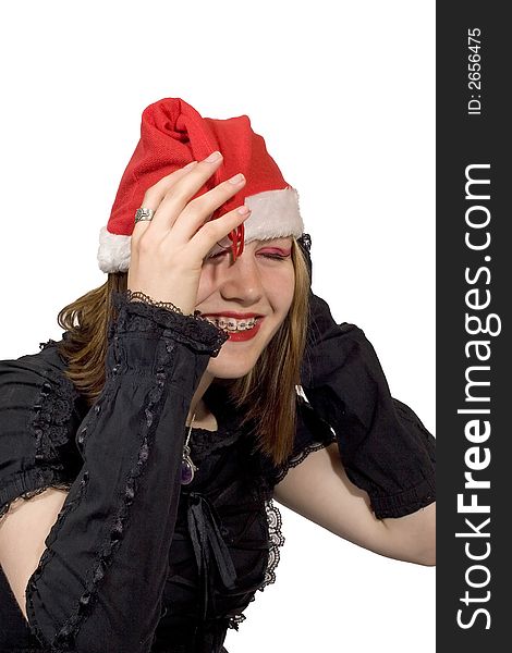 A pretty young lady in a christmas hat laughing. A pretty young lady in a christmas hat laughing