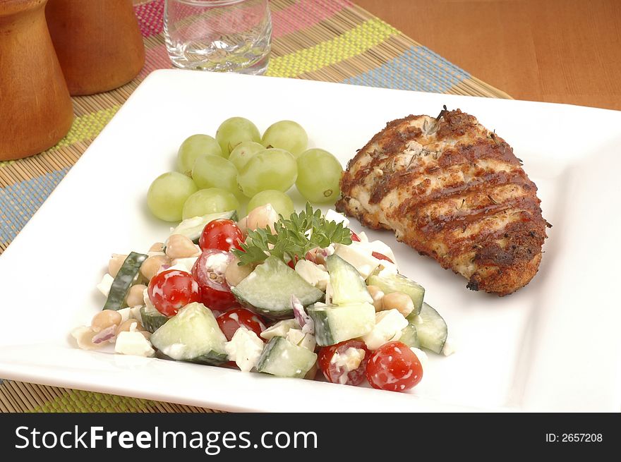 Summer salad served with grilled chicken and grapes.