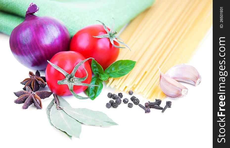 Pasta, spices and vegetables on a white background. Pasta, spices and vegetables on a white background