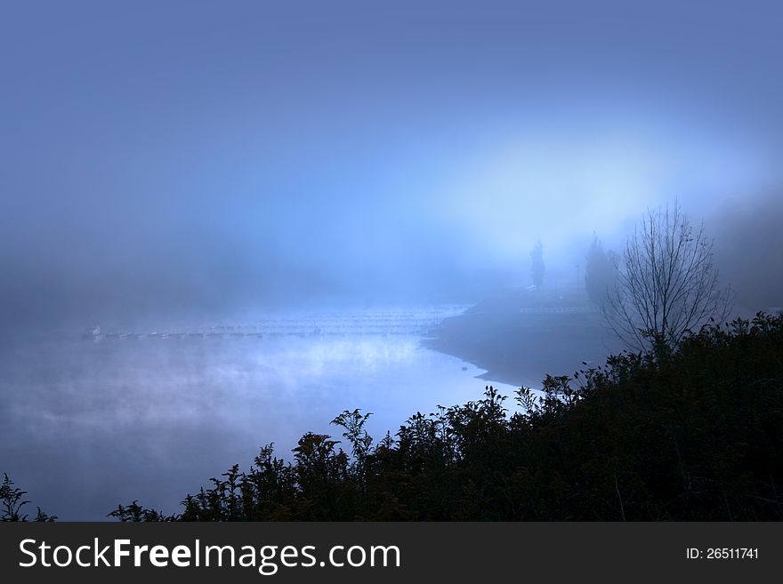 Misty morning with sun raise over lake