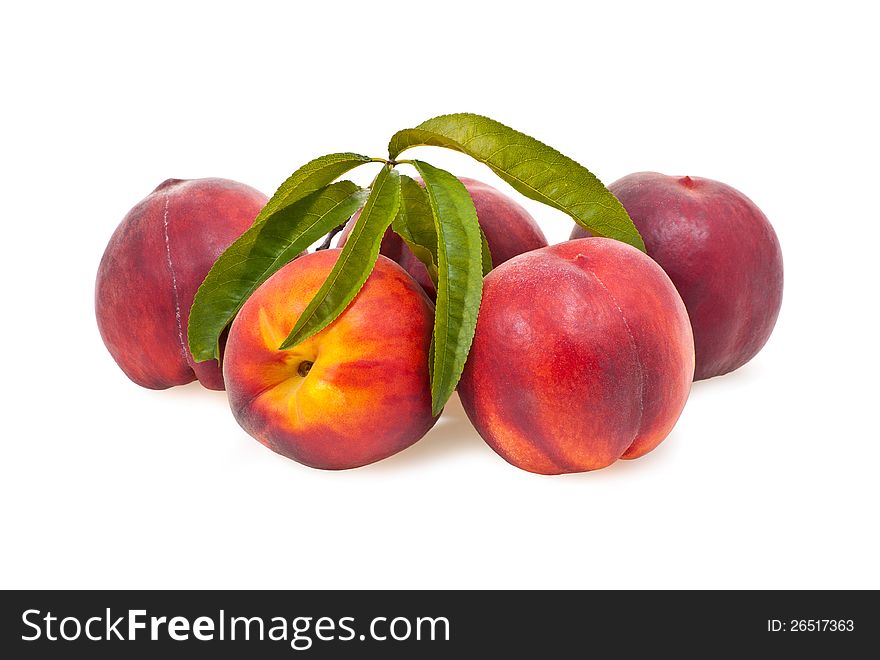 Five peaches with foliage on a white background