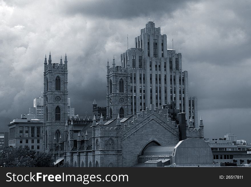 Moody monochrome image of Notre Dame Cathedral and other old buildings on a stormy cloudy background. Moody monochrome image of Notre Dame Cathedral and other old buildings on a stormy cloudy background.