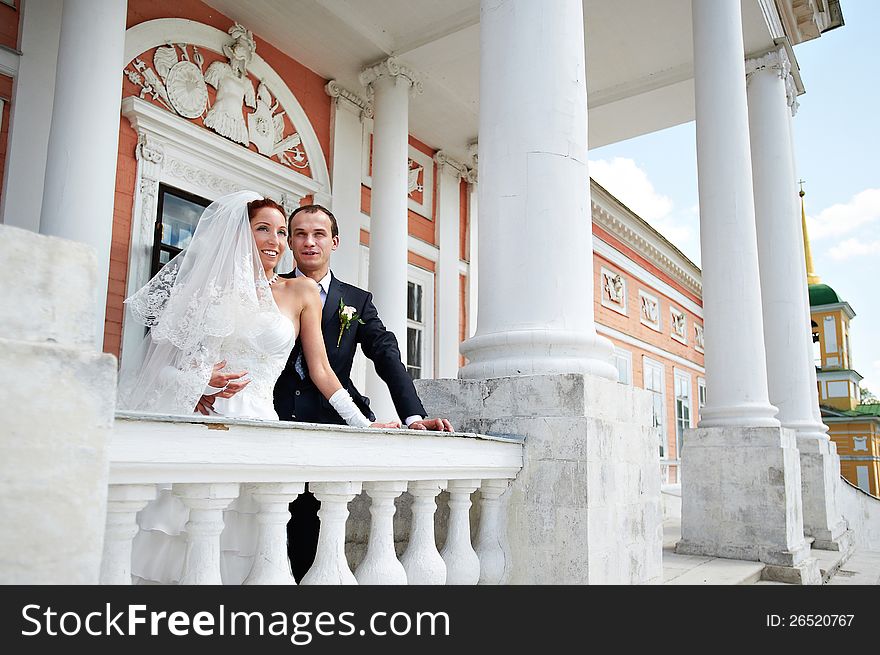 Happy bride and groom in ancient building