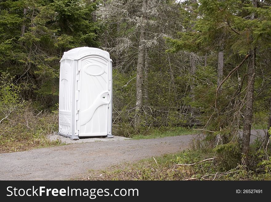 White outhouse on the edge of a forest. White outhouse on the edge of a forest