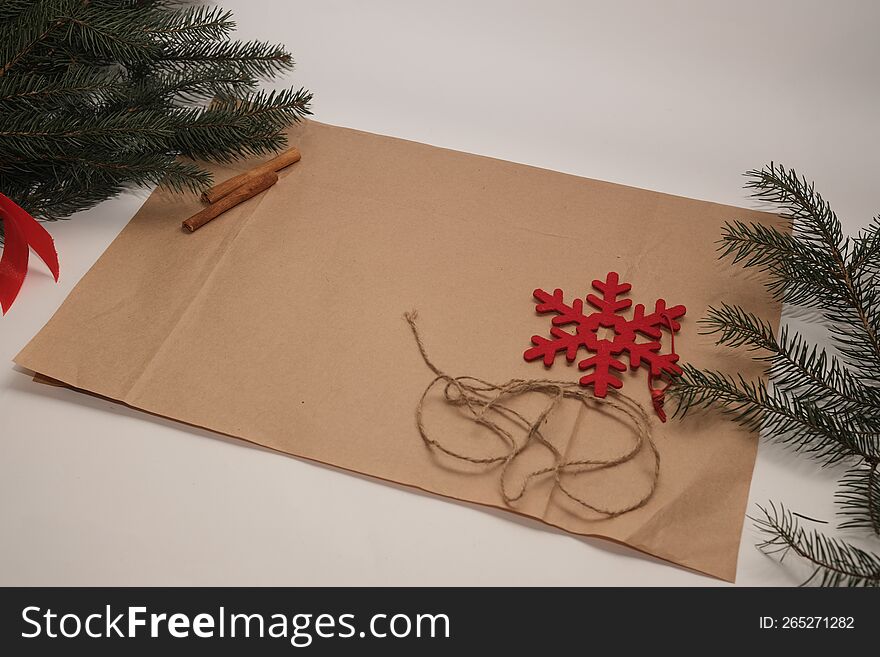 Christmas background with cinnamon, brown paper and fir branches