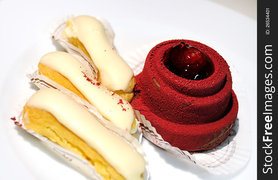 Cakes with cream, on a white plate