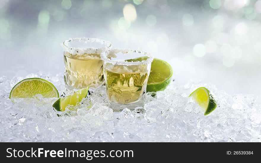 Gold tequila with salt and lime on a ice.