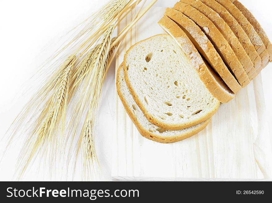 Fresh sweet bread on the table with wheat
