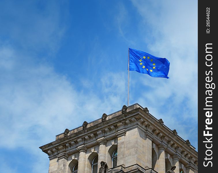 Europe flag on old european building flying on blue sky. Europe flag on old european building flying on blue sky