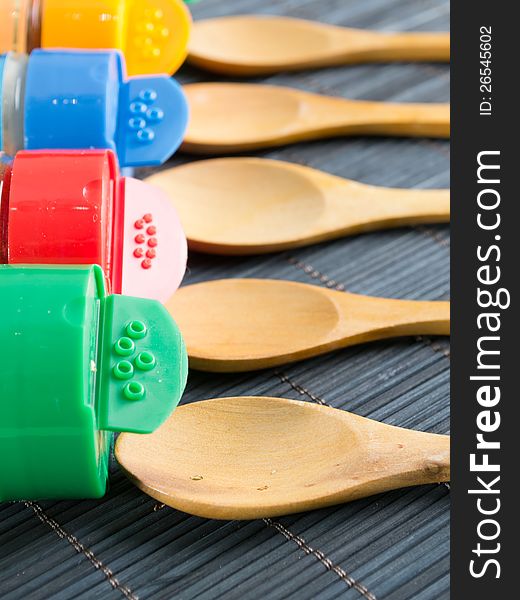 Wooden spoons and  bottles with spices,close up