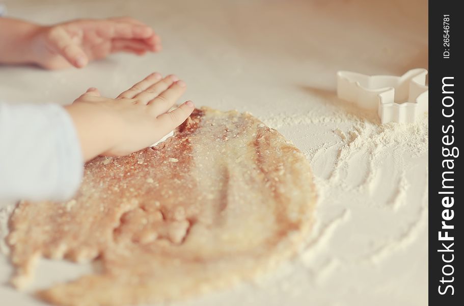 Children's hands make molds for pastry dough. Children's hands make molds for pastry dough