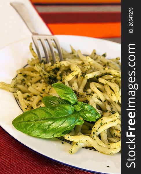 A plate of pasta with pesto