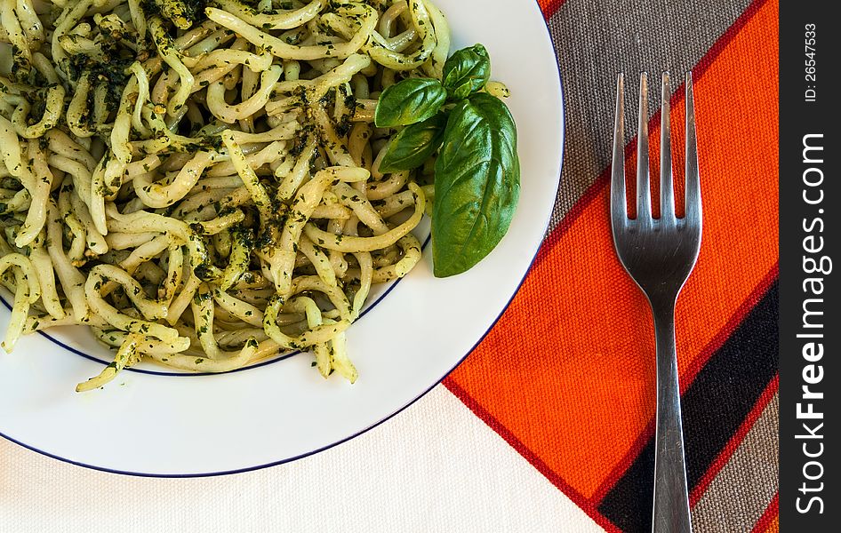 A plate of pasta with pesto