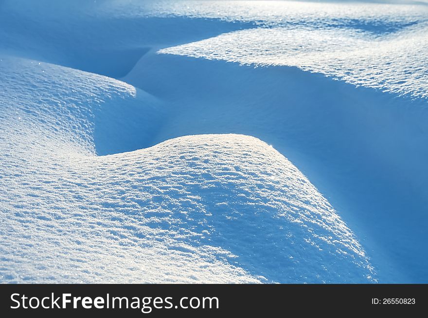 Snow drifts in the sunlight. Snow drifts in the sunlight.