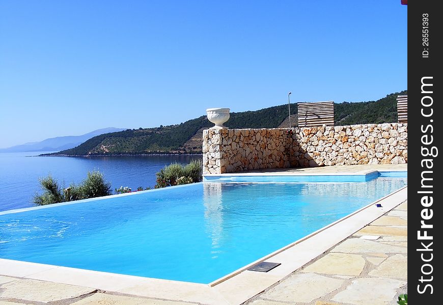 This image presents a very nice pool on the shore of the Mediterranean sea with a beautiful view. This image presents a very nice pool on the shore of the Mediterranean sea with a beautiful view.
