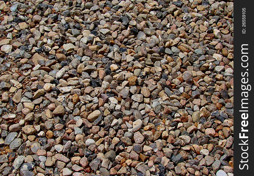 Pebbles on the road - texture or background. Pebbles on the road - texture or background