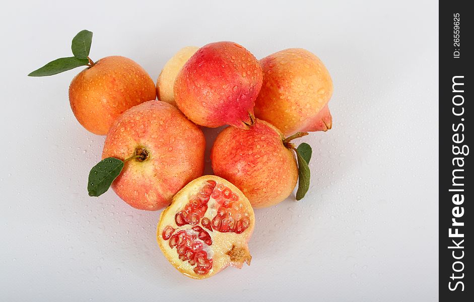 Stacked Fresh Picked Yellow and Red Pomegranates