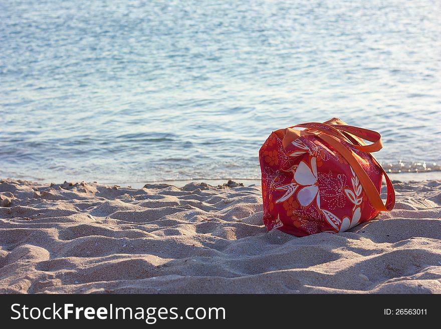 Summer beach bag on sandy beach. Summer beach bag on sandy beach