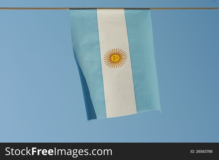 Argentina flag waves in a blue sky