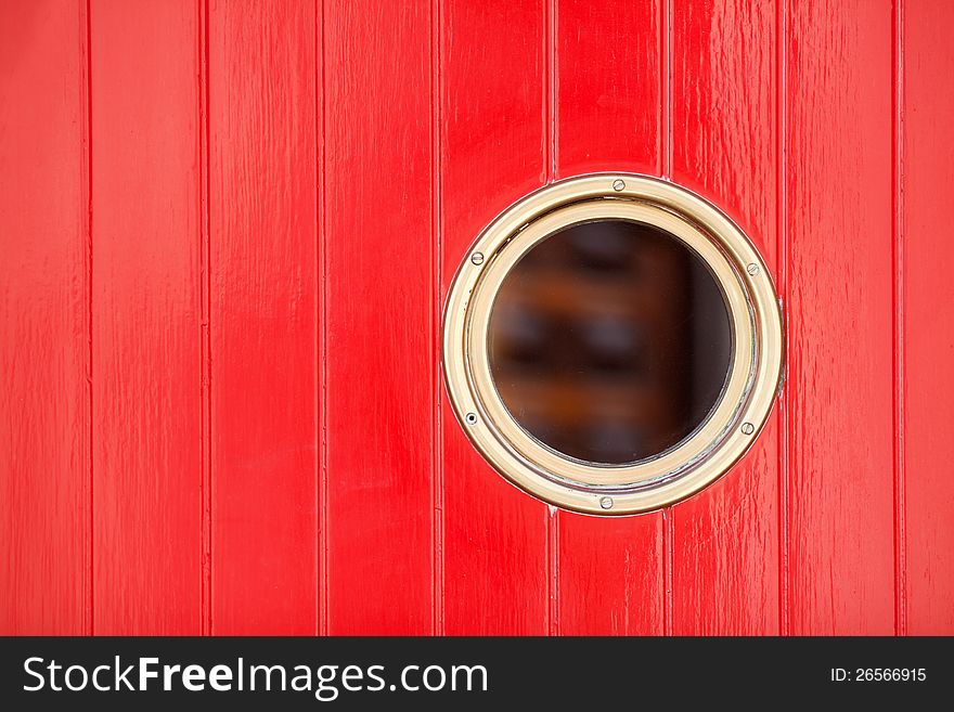 Decorative picture of red painted wood panels (entrance door) with a bull's eye. Decorative picture of red painted wood panels (entrance door) with a bull's eye