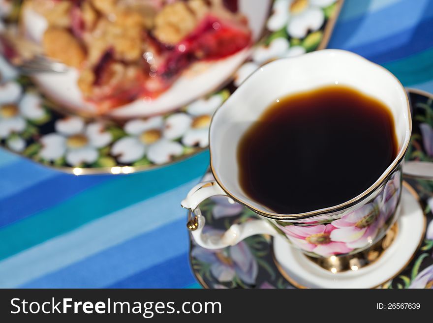 A cup of coffee and a piece of homemade plum cake. A cup of coffee and a piece of homemade plum cake