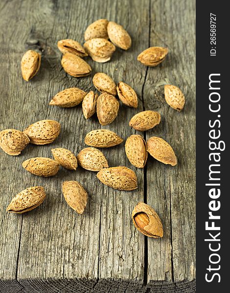 Almonds in shell on wooden table