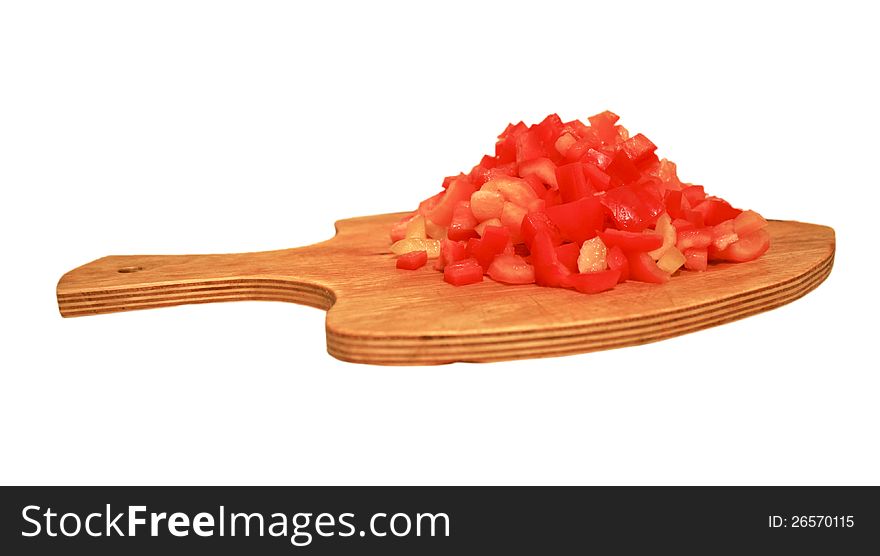 The photo of appetizing heap of fresh juicy red cut pepper on chopping board, isolated on white. The photo of appetizing heap of fresh juicy red cut pepper on chopping board, isolated on white