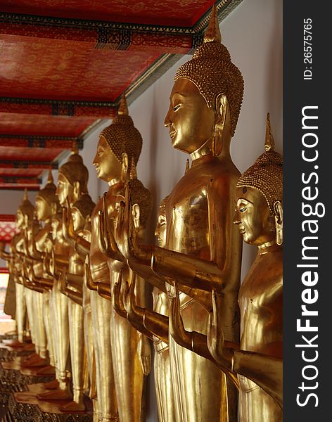 A row of golden buddha statues in bangkok, thailand. A row of golden buddha statues in bangkok, thailand