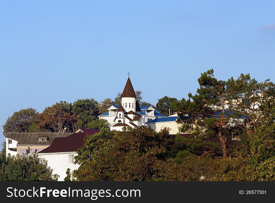 Church among green trees on the background of hills. Church among green trees on the background of hills