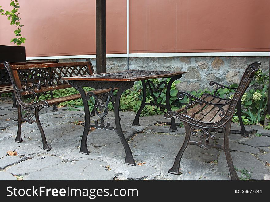 Empty decorative garden table and benches. Empty decorative garden table and benches