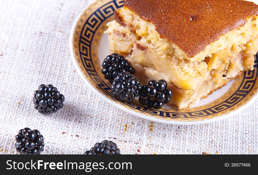 Freshly made apple pie served with blackberries. Freshly made apple pie served with blackberries