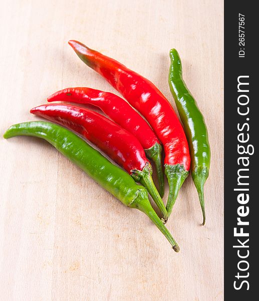 Red and green chili peppers on a white background