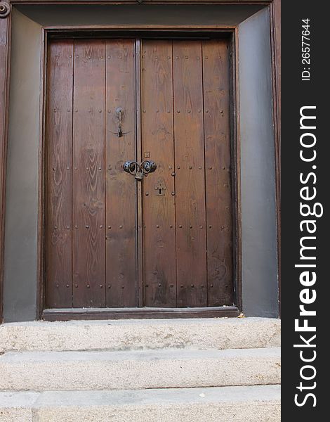 Wooden door with stone stairs in front of it