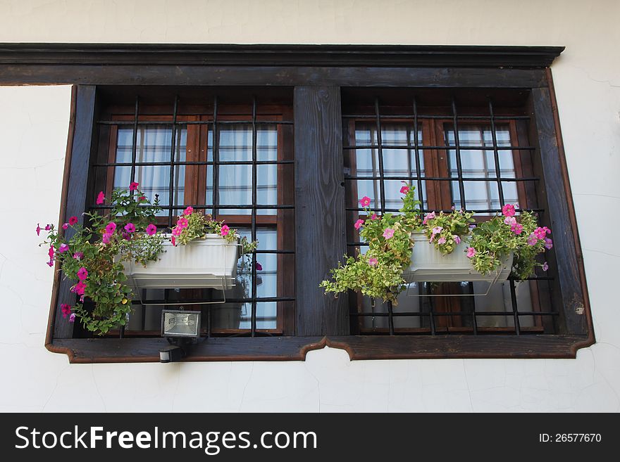 Wooden windows with fresh flowers in front of them