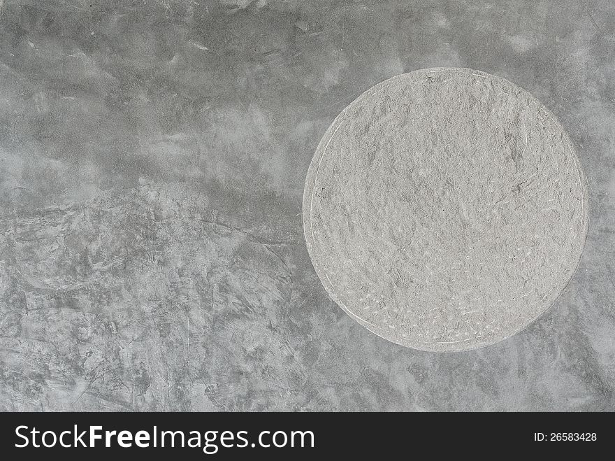 Plain cement wall with round rough texture insert